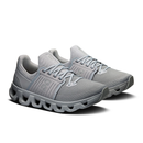 Gray running shoes with unique sole design on a white background