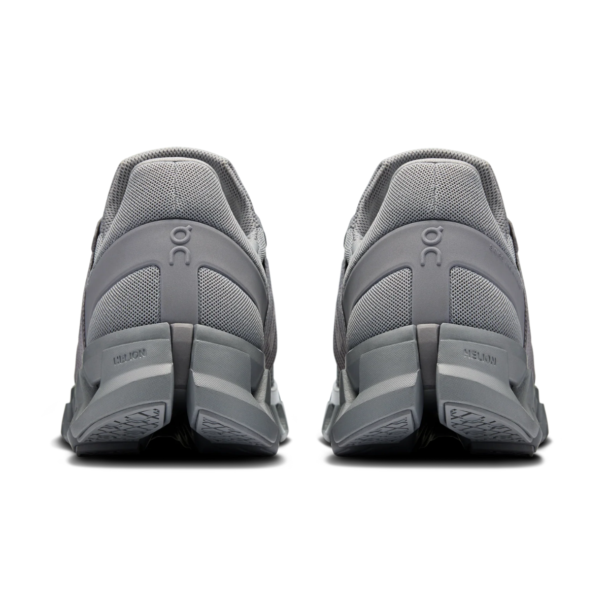 Gray athletic shoes with 'On' branding on a white background