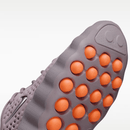 Close-up of a shoe sole with orange凸起 on a white background
