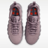 Pair of light purple sneakers with red accents on a white background