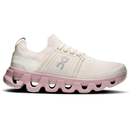 White and pink running shoe with unique sole design on a white background